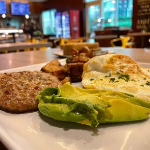 a plate of food with eggs and avocado