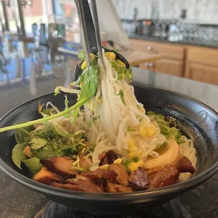 a bowl of ramen and vegetables