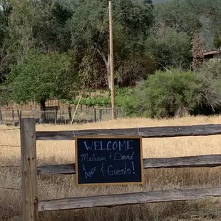a welcome sign on a wooden bench