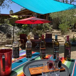 a picnic table with wine bottles and glasses