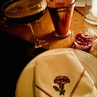 a plate with a napkin and a glass of wine