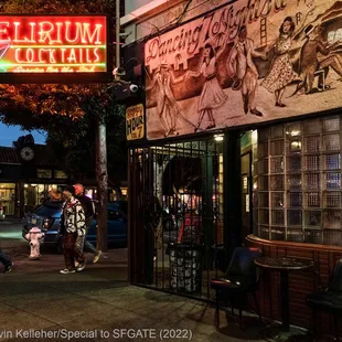 people walking in front of a delirium restaurant