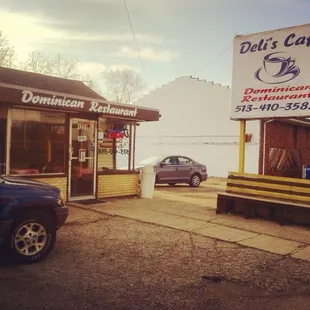 a car parked in front of a deli's cafe