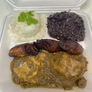 Full to-go asado negro plate. White rice, plantains, black beans, and stewed eye of round.