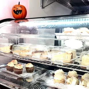 a display case filled with cupcakes