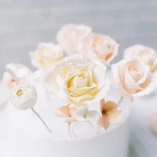 a closeup of a white cake with flowers
