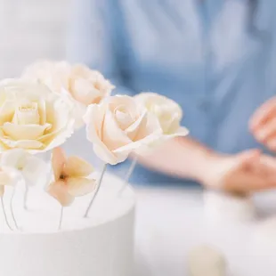 a woman sitting in front of a cake