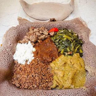 Meat combo includes tibs, gomen, cheese, kaye wot, kitfo, alicha wot and 2 injera for just $25. 5/5. IG: @take.a.bite.with.me