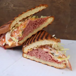 T&apos;s Corn Beef Special stuffed with Hoagie, Swiss Cheese, Horseradish Pickles, Onions, deli and thousand island dressing.