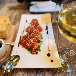 a plate of food and a glass of wine