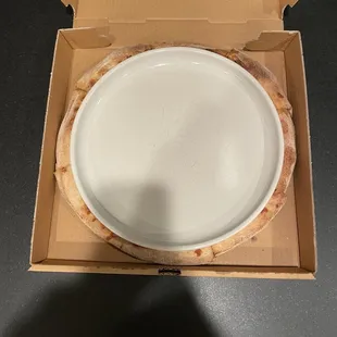 Medium size dinner plate covering pizza