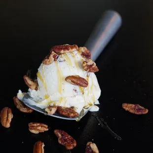 a scoop of ice cream and pecans