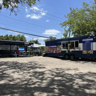 a blue food truck parked in a parking lot