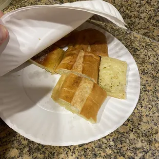 a paper plate with a sandwich on it
