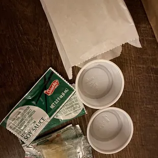 the contents of a coffee cup, a paper bag, and two cups