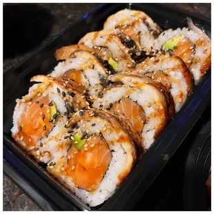 sushi rolls in a plastic container