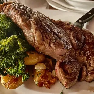 Grilled prime rib with mashed potatoes and broccoli.
