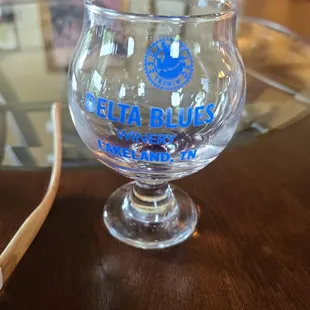 a glass and a toothbrush on a table