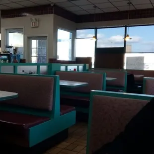 a woman sitting at a table in a diner