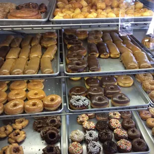 a variety of doughnuts in a display case