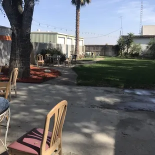 a patio with chairs and tables