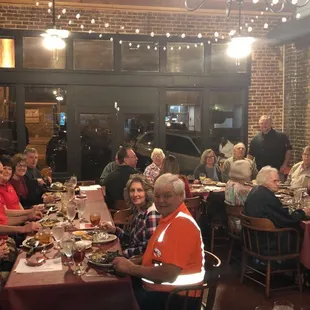a large group of people sitting at a table