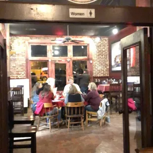 people sitting at tables in a restaurant