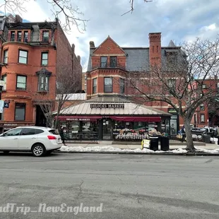 a car parked in front of a deluca shop