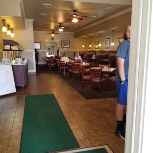 a man standing in the doorway of a restaurant