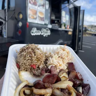 a plate of food in front of a food truck