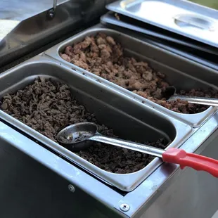 two pans of food being cooked