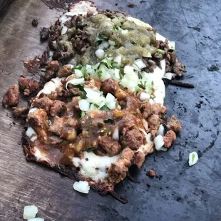 a pizza with meat and onions