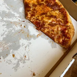 a half eaten pizza in a box