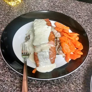 Fresh salmon from Demarias, pan seared over a bed of wild rice. Served with a white wine sauce and organic steamed carrots.