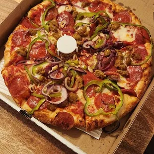 Large pepperoni, sausage, bell pepper, &amp; red onion pizza my husband ordered.