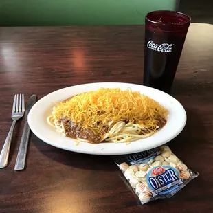 a plate of spaghetti and a drink