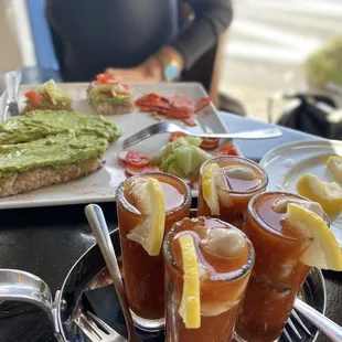 Oyster Shooters* with tequila  Avocado Toast* with a side of salmon cocktail by Javier