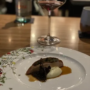 a plate of food and a glass of wine