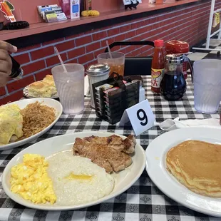 Portions portions portions! Grits + pork chops + pancake + biscuits + hash browns + and cheese eggs