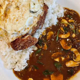 Tonkatsu curry rice plate with an additional well done egg, spinach and mushrooms