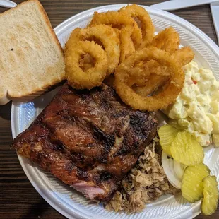 Pork and ribs with onion rings and potato salad