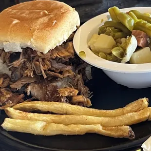 Pork &amp; brisket sandwich with a side of green beans (had minced bacon &amp; cubed potatoes)