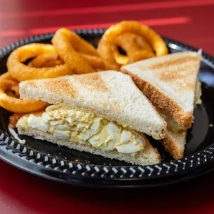 a sandwich and onion rings