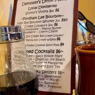 a menu and a glass of wine