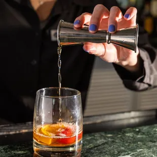 a bartender pouring a drink