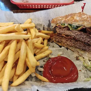 Double patty bacon cheeseburger with fries.