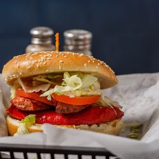 a hamburger with lettuce, tomato, and cheese