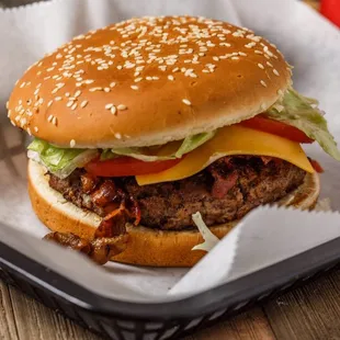 a hamburger with lettuce, tomato, and cheese