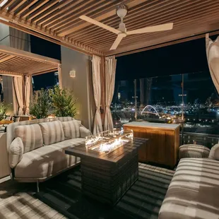 Fireside seating in Denim&apos;s Rooftop Cabanas