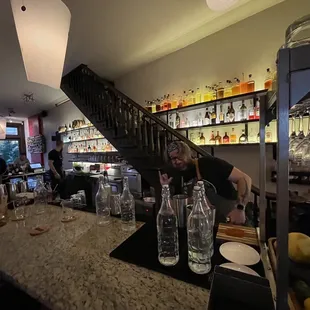 a man pouring a drink at a bar